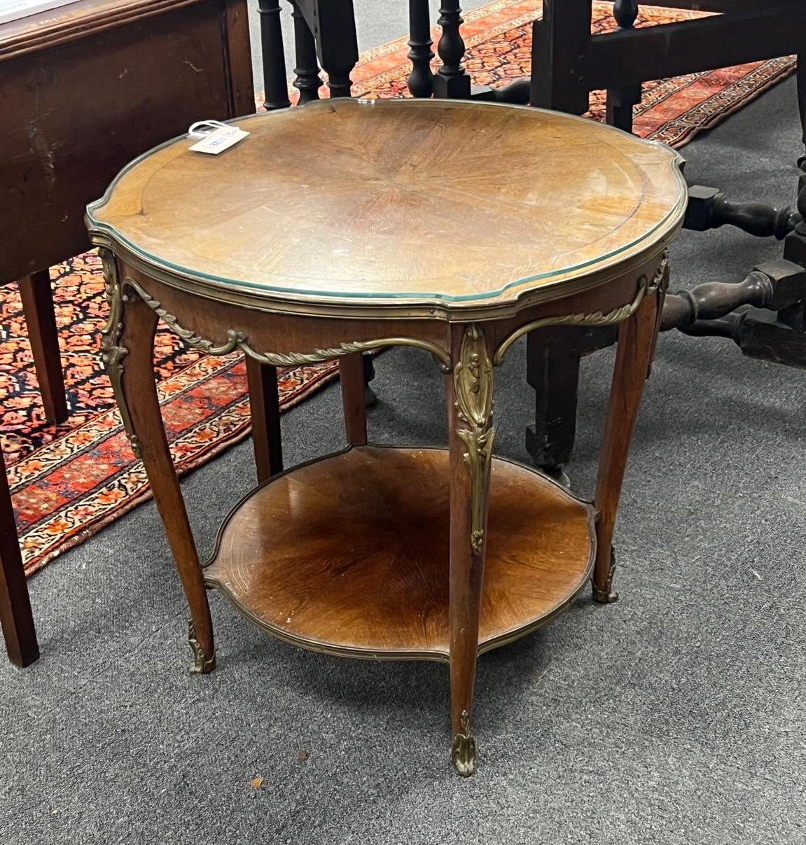 A Louis XVI style gilt metal mounted circular mahogany two tier occasional table, diameter 61cm, height 57cm